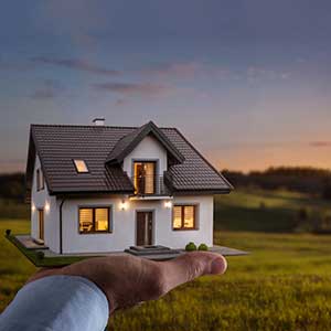 hand holding a miniature house